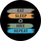 Spare tire cover with a brushed design and the words eat, sleep, hike, repeat. Spare tire cover is made to order for a JL backup camera.