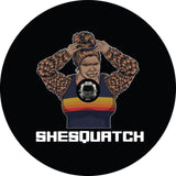 Shesquatch putting her hair in a top knot messy bun black vinyl custom spare tire cover with a JL back up camera design