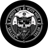 Unique spare tire cover design with a skull wearing a captains hat smoking a pipe and a compass style background with the saying a smooth sea never made a skilled sailor on the edge. Custom wheel cover that's made to order for any make and model vehicle.