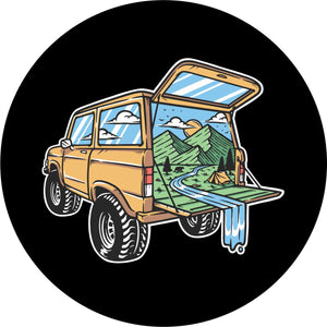 A creative and unique spare tire cover design with a Ford Bronco SUV and the mountains and outdoors beautiful camping scene coming out of the back. 