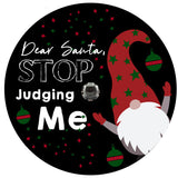 Funny spare tire cover saying Dear Santa, Stop Judging Me with a Christmas Scandinavian gnome popping out. Tire cover is designed to fit spare tires outfitted for a backup camera