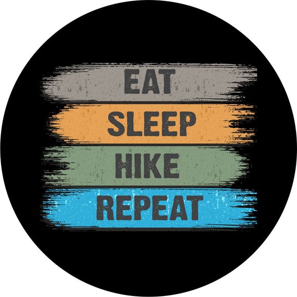 Spare tire cover with a brushed design and the words eat, sleep, hike, repeat.