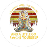 White vinyl colorful goddess spare tire cover design of a women sitting criss-crossed and a funny quote around the edge and below.