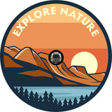 Spare tire cover with a camera hole for back up camera of a mountain and sea landscape with the words explore nature over the top. 