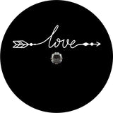 A simple spare tire cover design on black vinyl with a back up camera design of the word love in a cursive font that with the beginning and end intended to look like an arrow. 