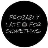 Plain black vinyl funny spare tire cover with the saying probably late for something in script text for any vehicle make and model wheel cover that has a back up camera in the center of the tire mount.